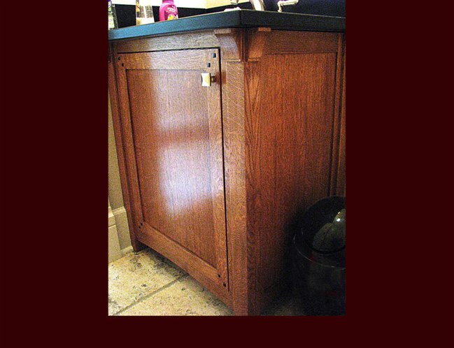 White Oak Vanity. Flat Panel Inset door style. Ebony inlays in doors. Post detail with corbels. Decorative end panel.