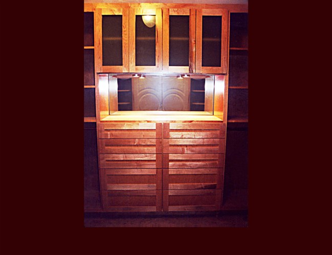 Maple Flat Panel Master Bedroom walk-in-closet (WIC) system. High drawer base with glass door upper cabinet shown.