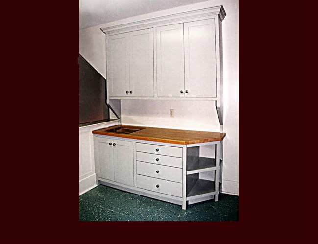 Painted Storage/Craft Cabinetry. Flat Panel Inset door style. Crown Moulding. Open corner shelving.