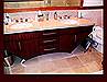 Bird's Eye Maple Master Bath Vanity. Contemporary slab fronts. Mahogany dyed finish. Stainless steel legs.