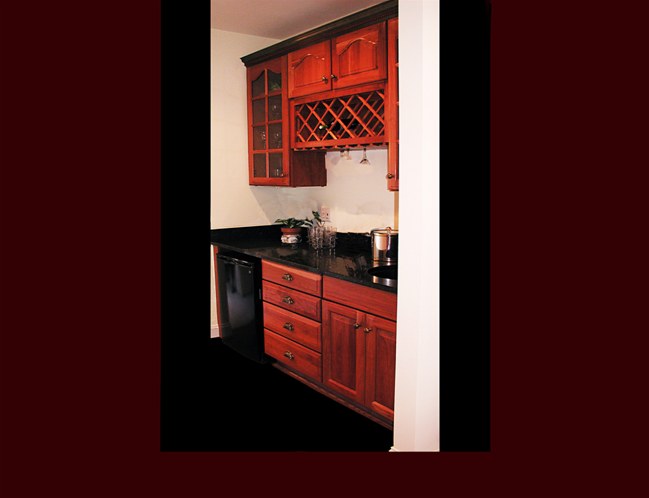 Cherry Butler's Pantry Cabinetry. Raised Panel door style. Cathedral door style on upper cabinets. Wine Rack with wine glass rack.