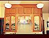 Custom Cherry Cabinets. Glass door cabinets with glass shelving and interior lighting. Light rail throughout.